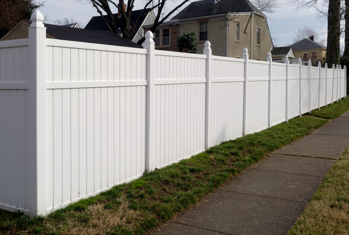 a house with a fence in front of a building
