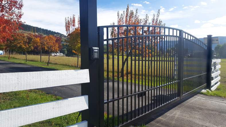 a bench on a sidewalk near a fence